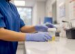 Nurse collecting urine sample for STD test