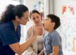 Nurse taking patient's temperature in clinic