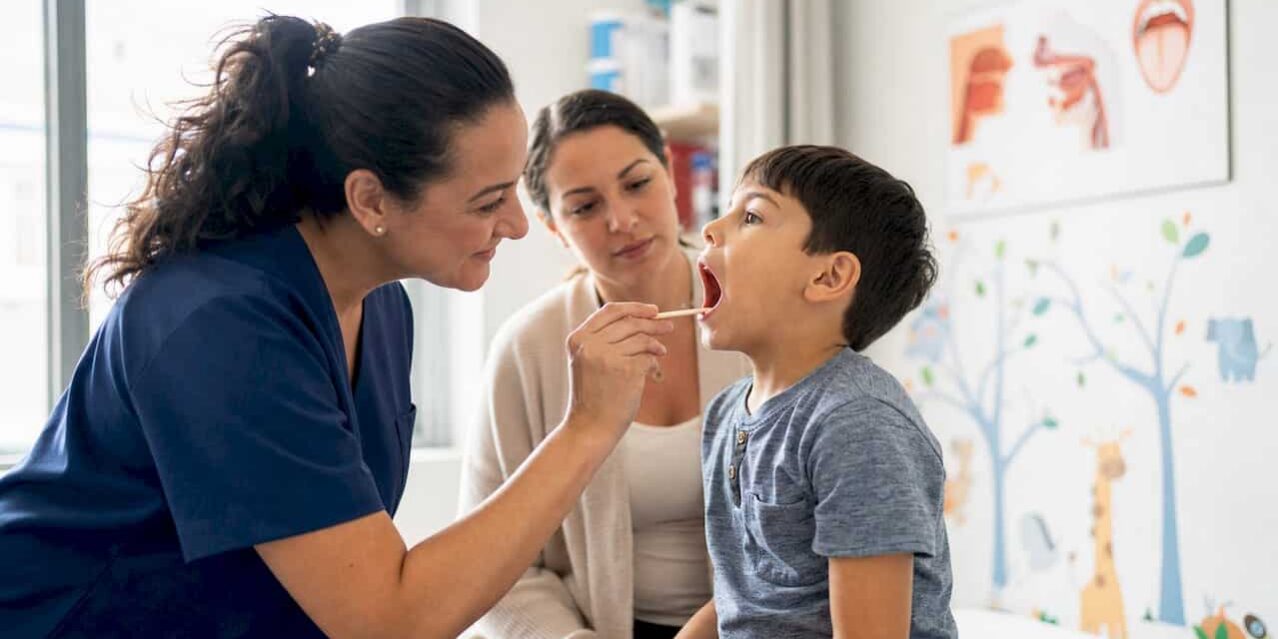 Nurse taking patient's temperature in clinic