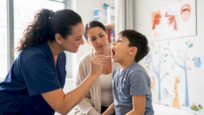 Nurse taking patient's temperature in clinic
