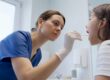 Clinician performing throat swab for strep test