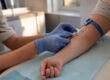 Clinician drawing blood for hepatitis C test