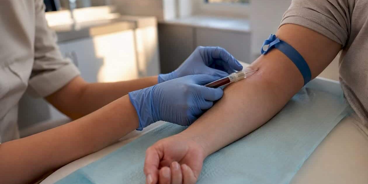 1786815156863_Clinician-drawing-blood-for-hepatitis-C-test Clinician drawing blood for hepatitis C test