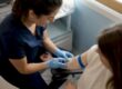 Nurse drawing blood for herpes test