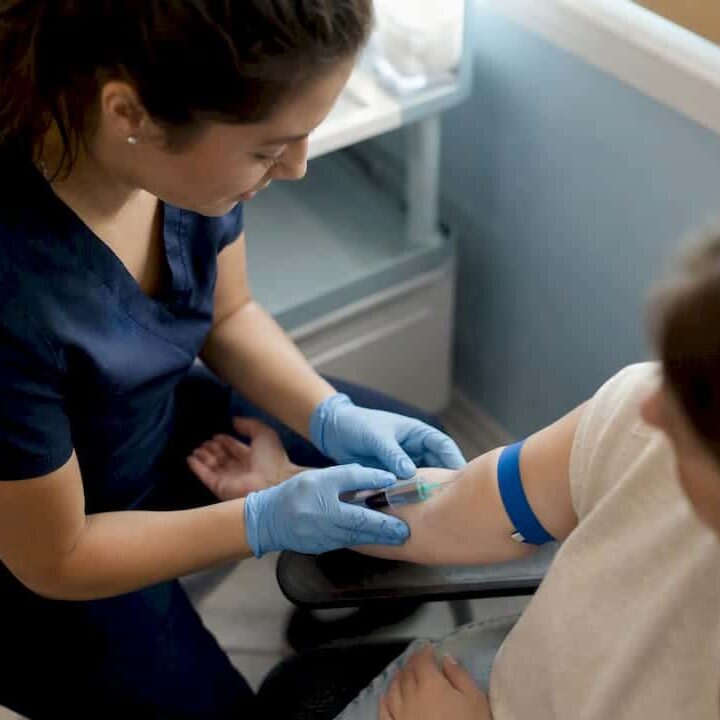 Nurse drawing blood for herpes test
