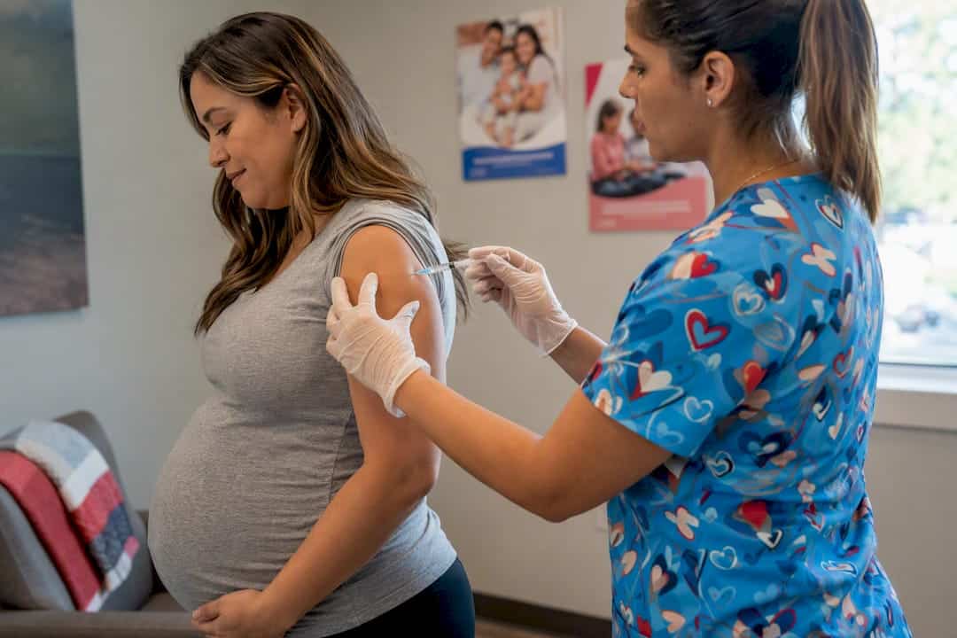 Pregnant woman getting vaccine in clinic
