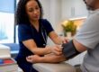 Clinician measuring adult blood pressure