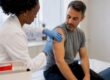 Clinician administering a flu vaccination