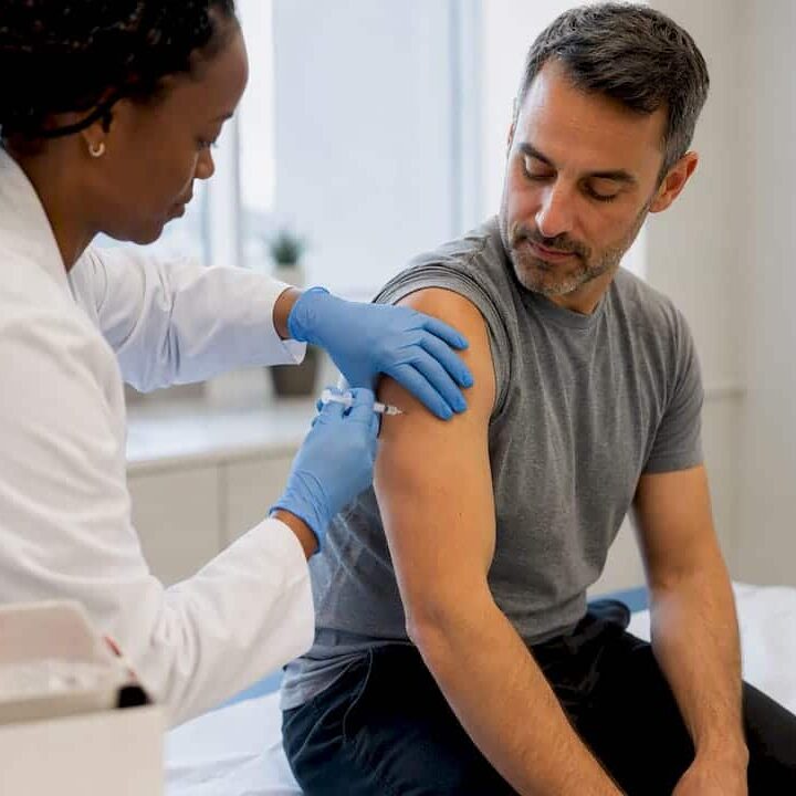 Clinician administering a flu vaccination