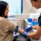 Clinician drawing blood from fasting patient