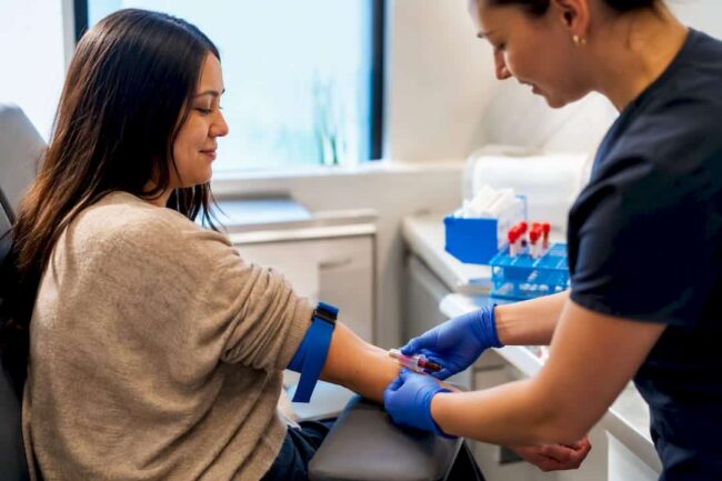 Clinician drawing blood from fasting patient