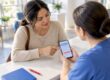 Parent verifying therapy coverage with clinic staff