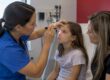 Clinician assessing child's red eye with parent