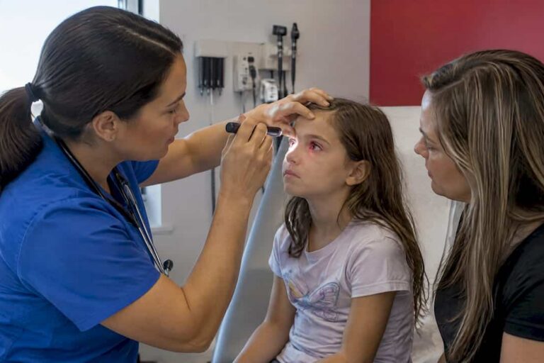 Clinician assessing child's red eye with parent