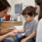 Clinician examining child’s HFMD palm rash
