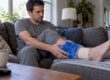 Adult applying a cold pack to an ankle