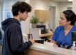 Teen asking clinic staff about insurance privacy