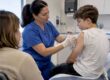 Nurse giving a vaccine to a teen