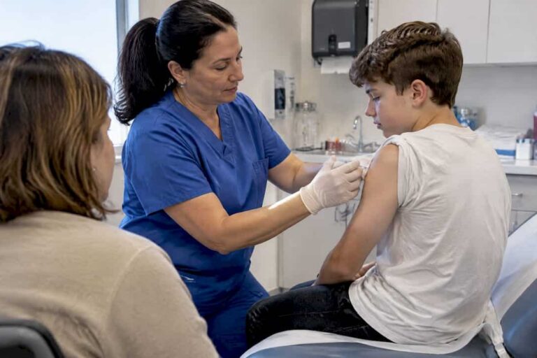 Nurse giving a vaccine to a teen