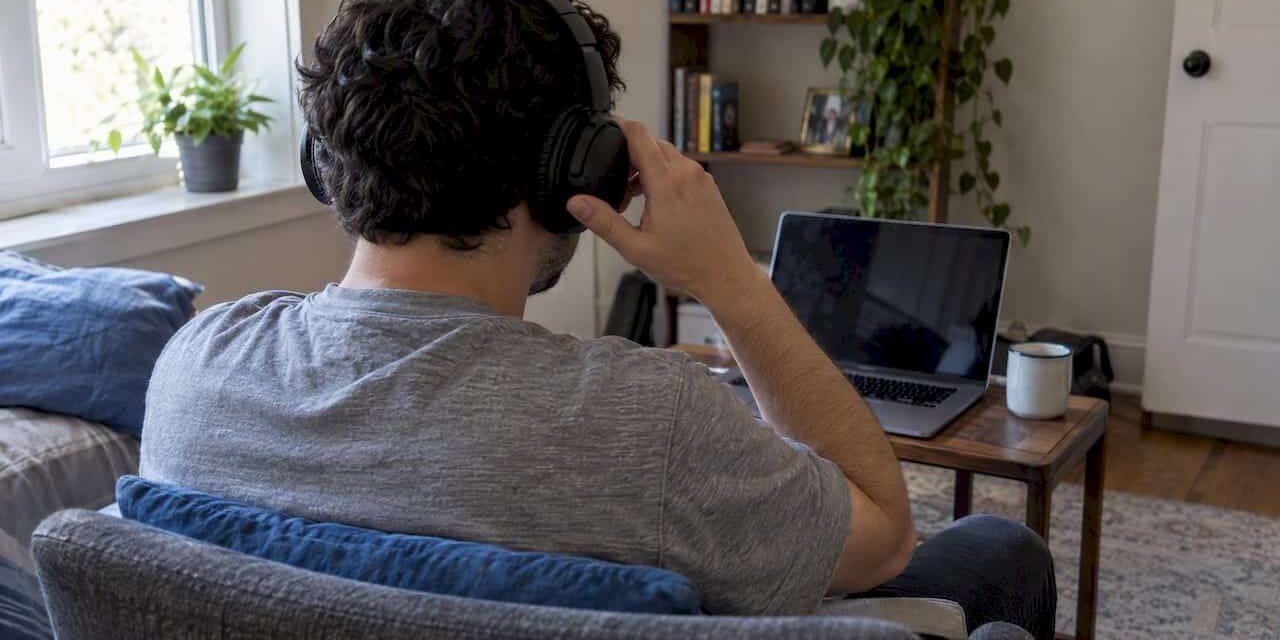 1792231771835_Patient-adjusting-headphones-before-online-therapy Patient adjusting headphones before online therapy