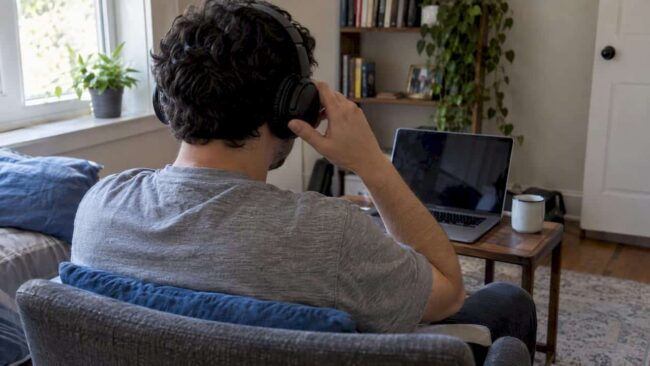 Patient adjusting headphones before online therapy