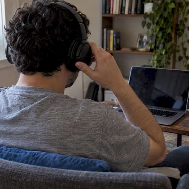 Patient adjusting headphones before online therapy