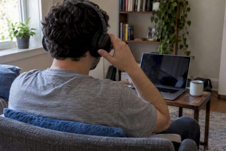 Patient adjusting headphones before online therapy
