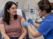 Adult receiving an HPV vaccine at a clinic