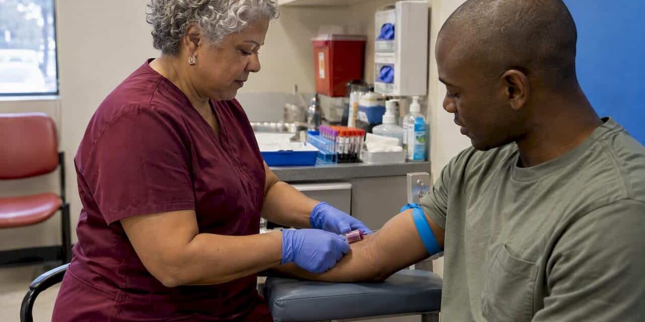 Clinician collecting a blood sample during screening