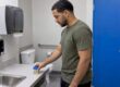 Patient places urine sample cup in clinic