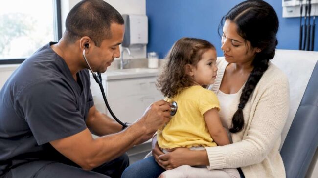 Clinician listening to a toddler’s chest