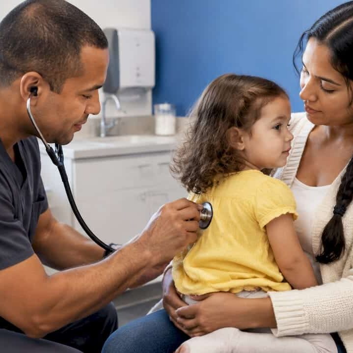 Clinician listening to a toddler’s chest